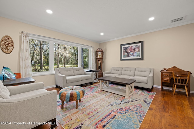 living room with dark hardwood / wood-style floors and crown molding