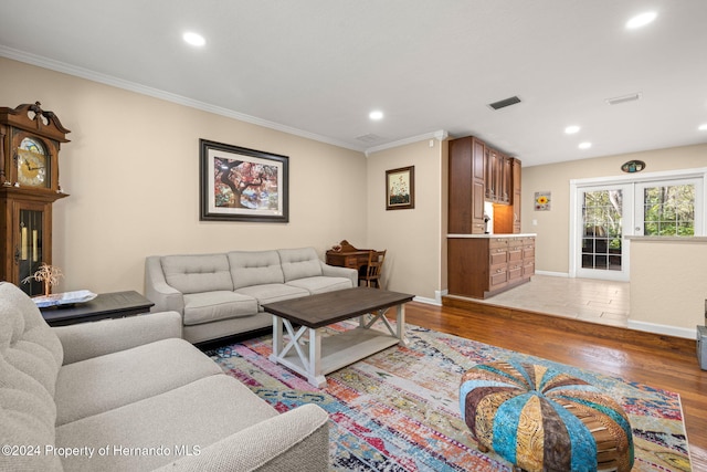 living room with hardwood / wood-style floors, french doors, and crown molding