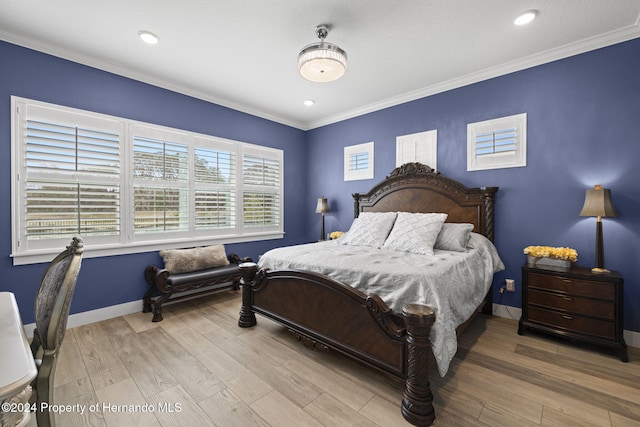 bedroom featuring crown molding and light hardwood / wood-style flooring