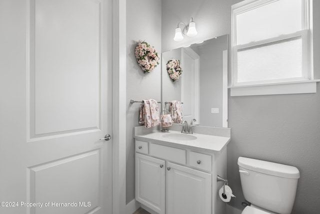 bathroom with vanity and toilet