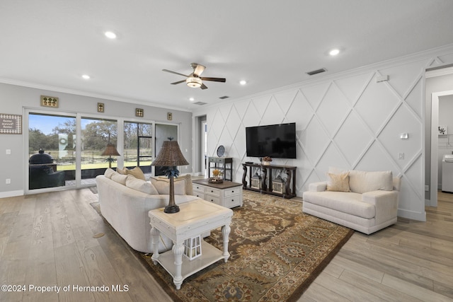 living room featuring light wood-type flooring, ceiling fan, and crown molding