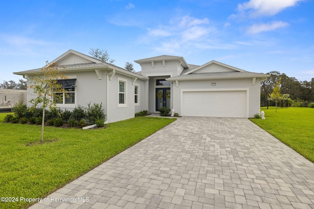 view of front of house with a garage and a front yard