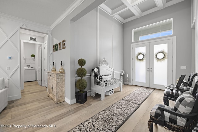 entryway featuring coffered ceiling, ornamental molding, light hardwood / wood-style flooring, and french doors