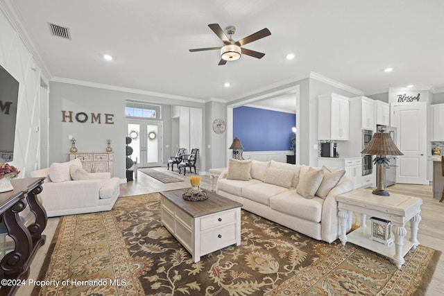 living room with hardwood / wood-style flooring, ceiling fan, crown molding, and french doors