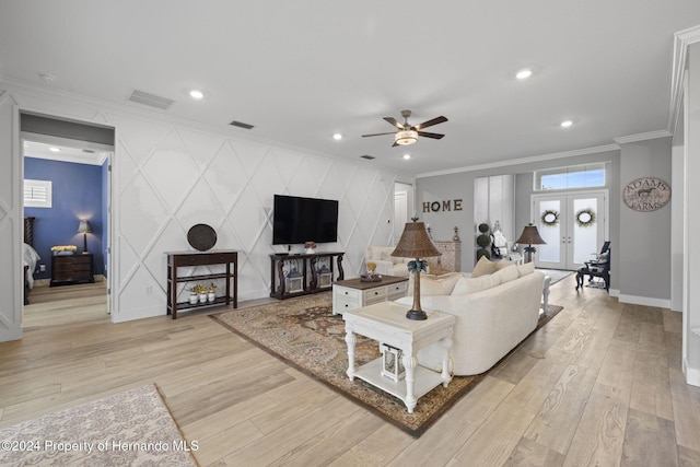 living room featuring ceiling fan, light hardwood / wood-style floors, and ornamental molding