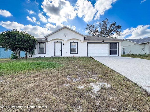 single story home featuring a garage and a front yard