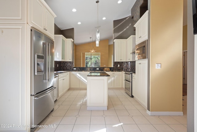 kitchen with tasteful backsplash, stainless steel appliances, a kitchen island, hanging light fixtures, and lofted ceiling