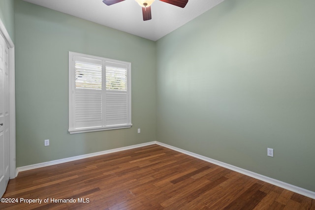 spare room featuring ceiling fan and dark wood-type flooring