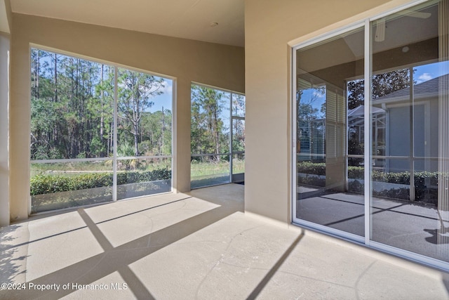 unfurnished sunroom featuring vaulted ceiling