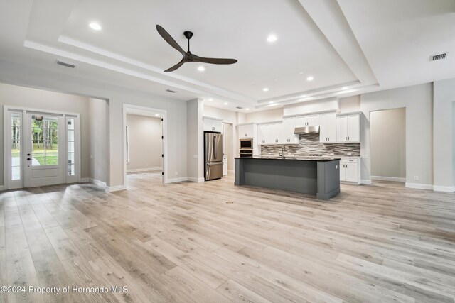 19504 Sheltered Hill Dr, Brooksville, FL 34601 - kitchen featuring a raised ceiling, appliances with stainless steel finishes, open floor plan, under cabinet range hood, and recessed lighting
