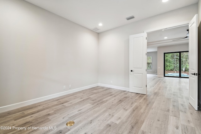 spare room featuring light wood-type flooring and ceiling fan