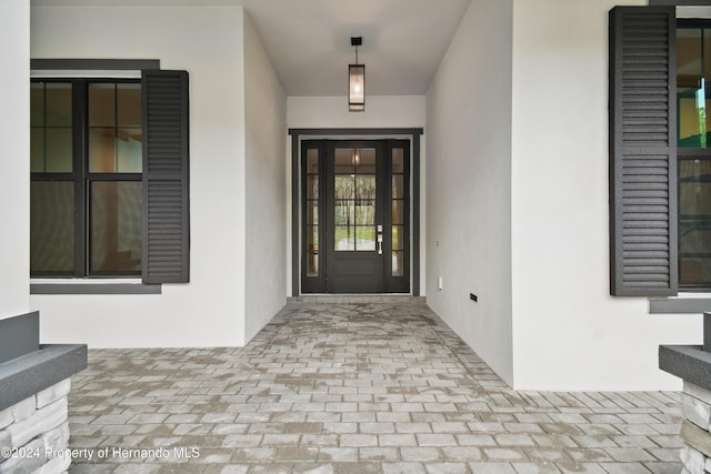 19504 Sheltered Hill Dr, Brooksville, FL 34601 - view of exterior entry featuring stucco siding