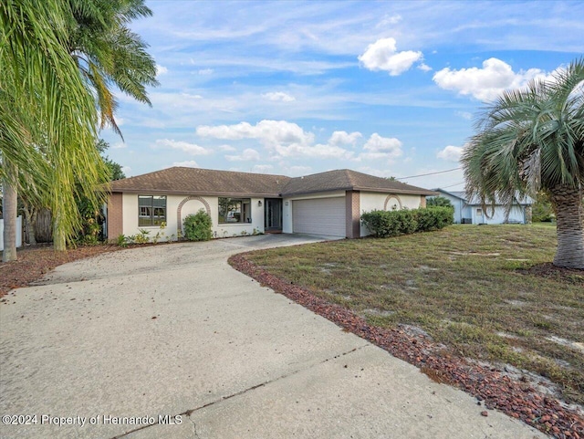 view of front of home featuring a garage and a front lawn