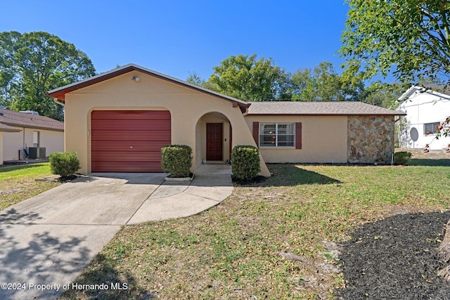 ranch-style house with a front yard and central AC