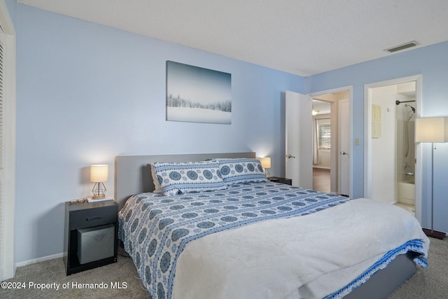 bedroom with carpet floors and ensuite bath