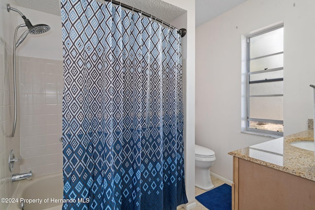 bathroom with vanity, a textured ceiling, and toilet