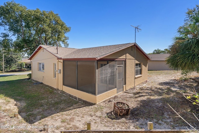 back of property featuring a sunroom