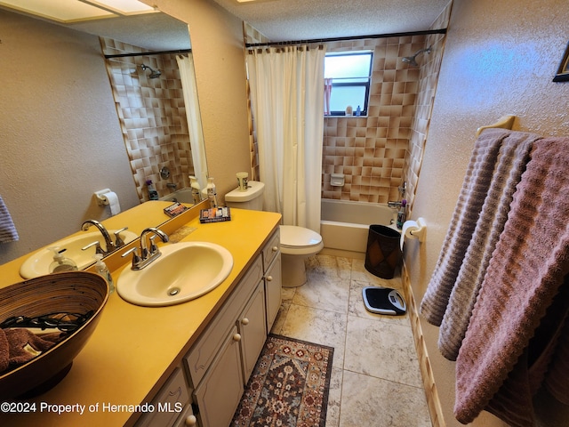 full bathroom featuring toilet, vanity, a textured ceiling, and shower / tub combo with curtain