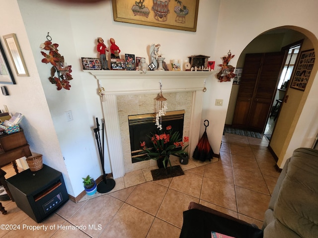 living room with a fireplace and tile patterned flooring