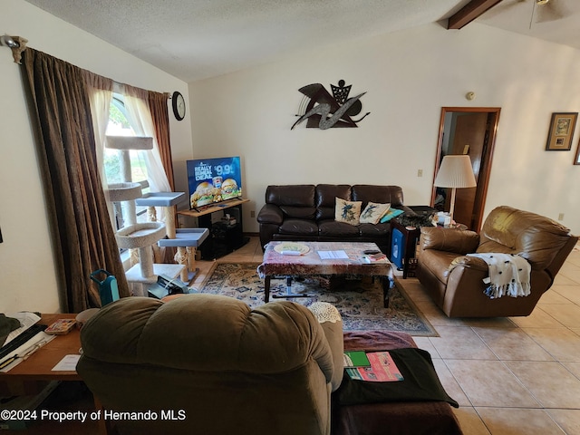 tiled living room featuring vaulted ceiling with beams and a textured ceiling