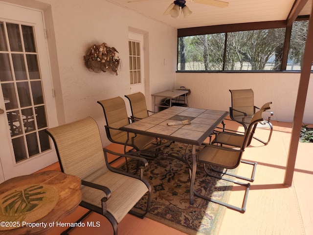 view of patio with a ceiling fan and outdoor dining area