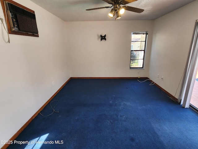 unfurnished room featuring a ceiling fan, carpet, a textured ceiling, and baseboards