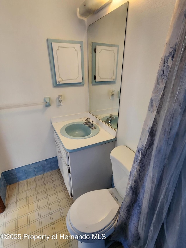 full bathroom featuring vanity and toilet