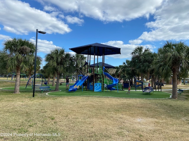 view of jungle gym with a lawn