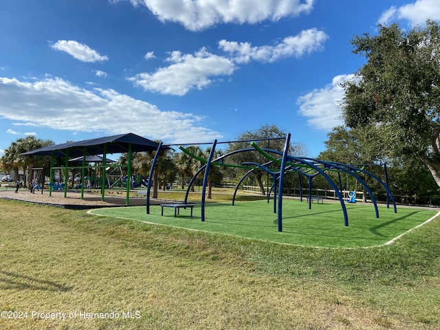 view of property's community with a playground and a yard