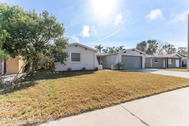 ranch-style house featuring a garage and a front lawn