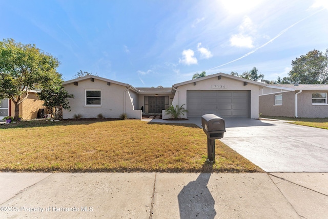 ranch-style home with a garage and a front yard