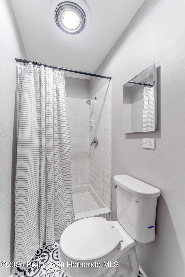 bathroom with toilet and walk in shower