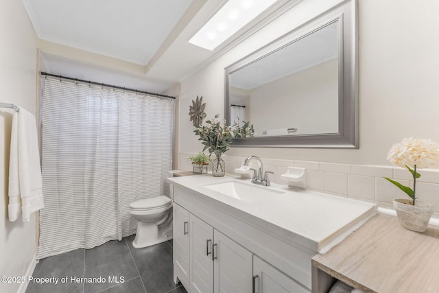 bathroom with vanity, a skylight, tile patterned floors, and toilet