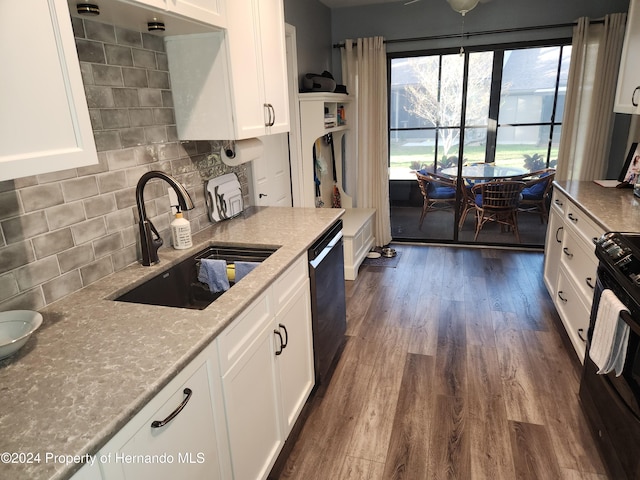 kitchen with dark wood-type flooring, black appliances, sink, light stone countertops, and white cabinetry