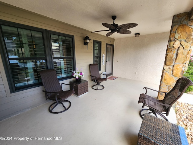 view of patio featuring ceiling fan and covered porch