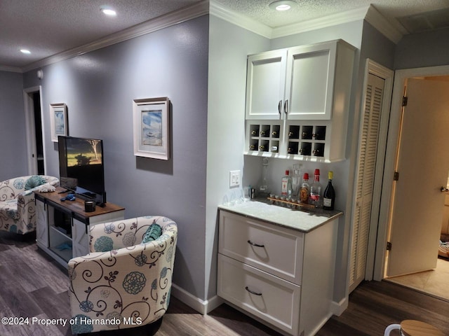 bar with a textured ceiling, dark hardwood / wood-style floors, and crown molding