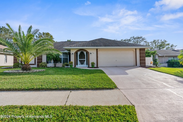 single story home with a front yard and a garage