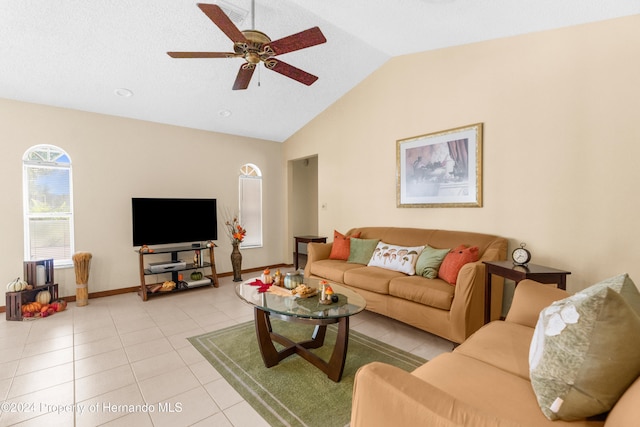 tiled living room with ceiling fan and lofted ceiling