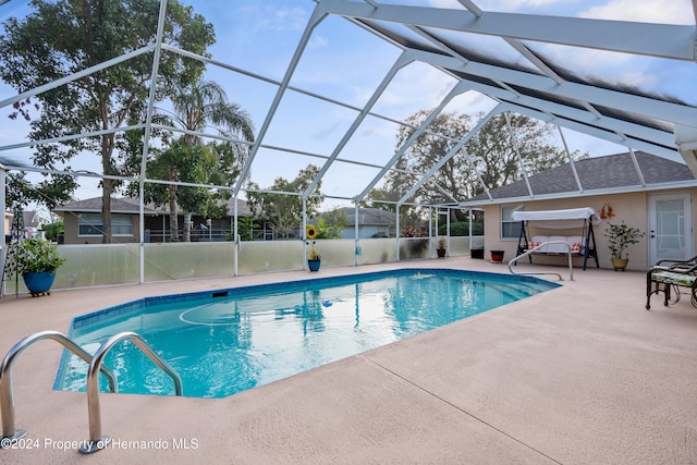 view of pool featuring a patio and a lanai