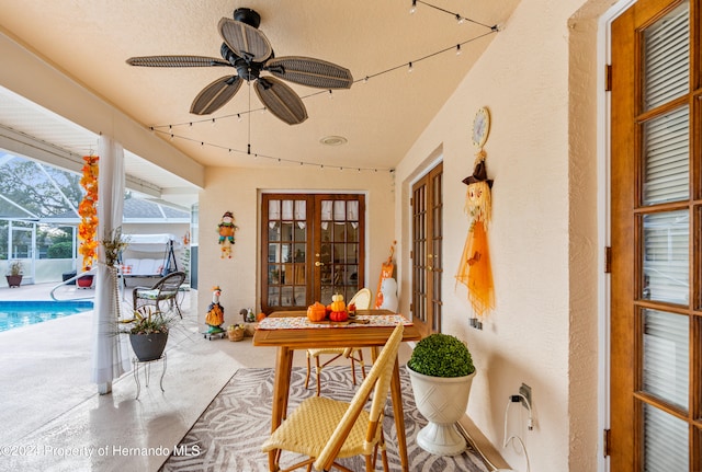 sunroom / solarium with french doors and ceiling fan