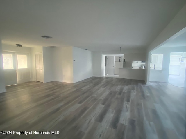 unfurnished living room with dark hardwood / wood-style floors