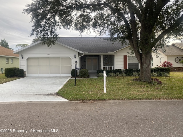 ranch-style home with a garage and a front lawn