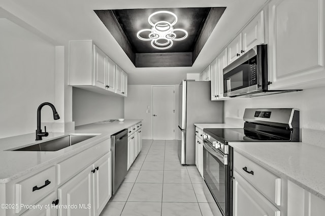 kitchen with white cabinetry, sink, light stone countertops, and appliances with stainless steel finishes