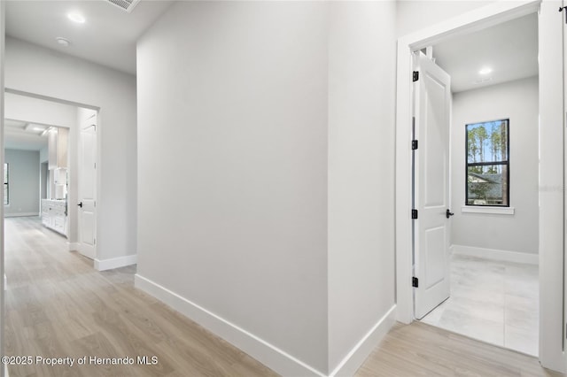 hallway with light wood-type flooring