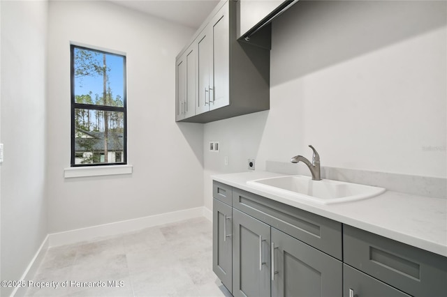 laundry area featuring cabinets, hookup for a washing machine, hookup for an electric dryer, and sink