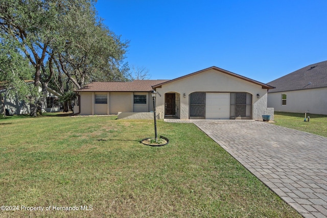 ranch-style home featuring a garage and a front yard