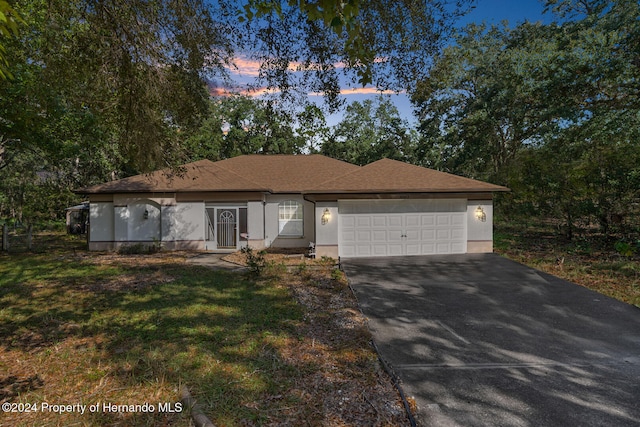 ranch-style house featuring a garage