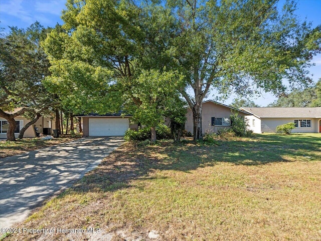 view of front of house with a front yard and a garage