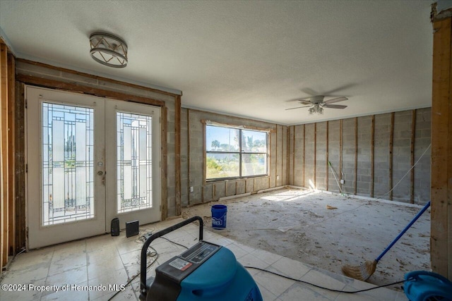 interior space with a textured ceiling and ceiling fan