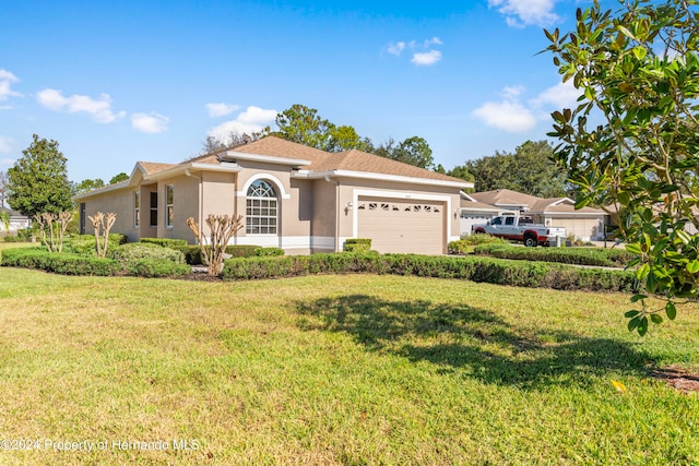 view of front of property featuring a garage and a front lawn